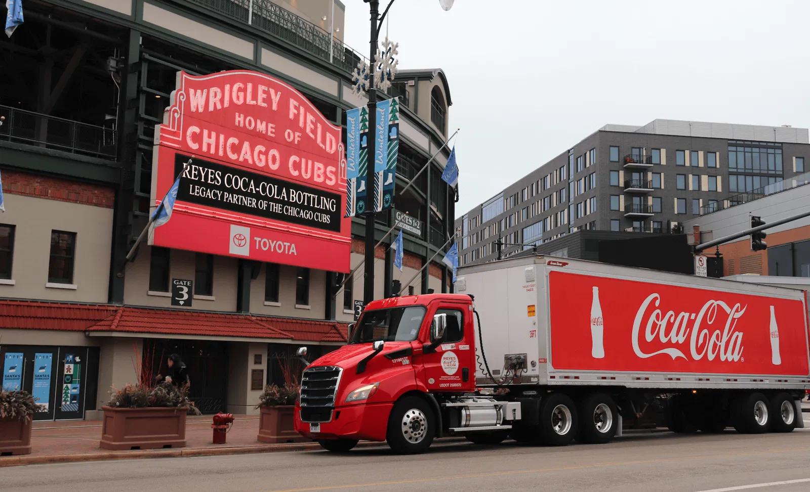 Coca-Cola truck parked in front of "Wrigley Field" building