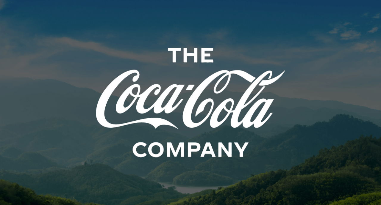 Coca-Cola logo against a backdrop of mountains