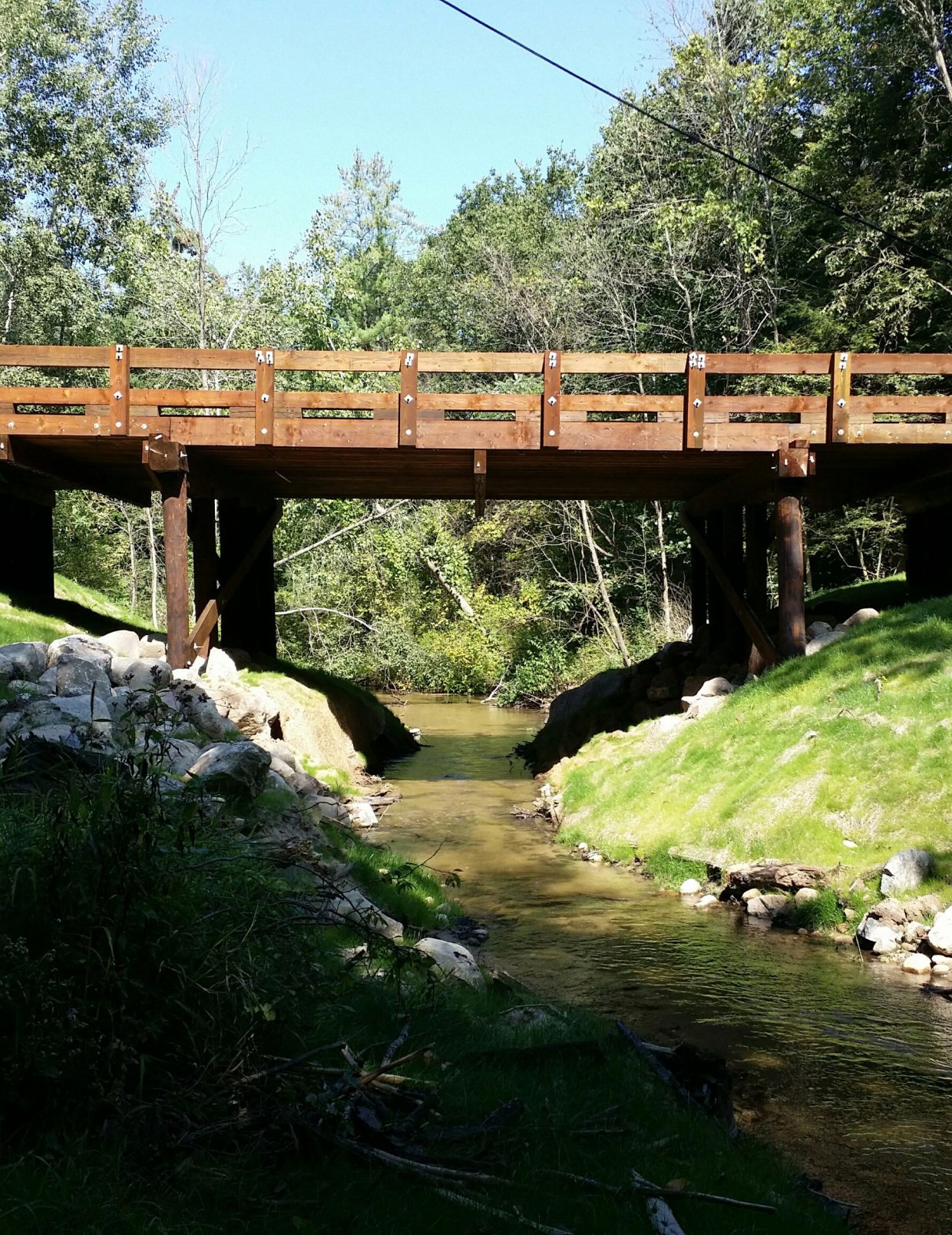 Wooden bridge over a small water stream