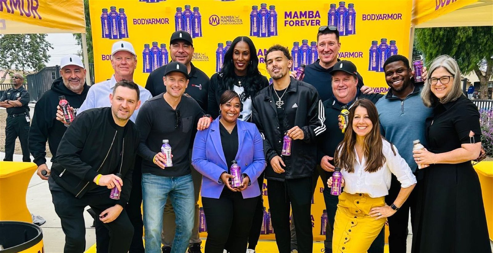 Group of people at a Mamba Foundation event, with Mamba bottles in hands